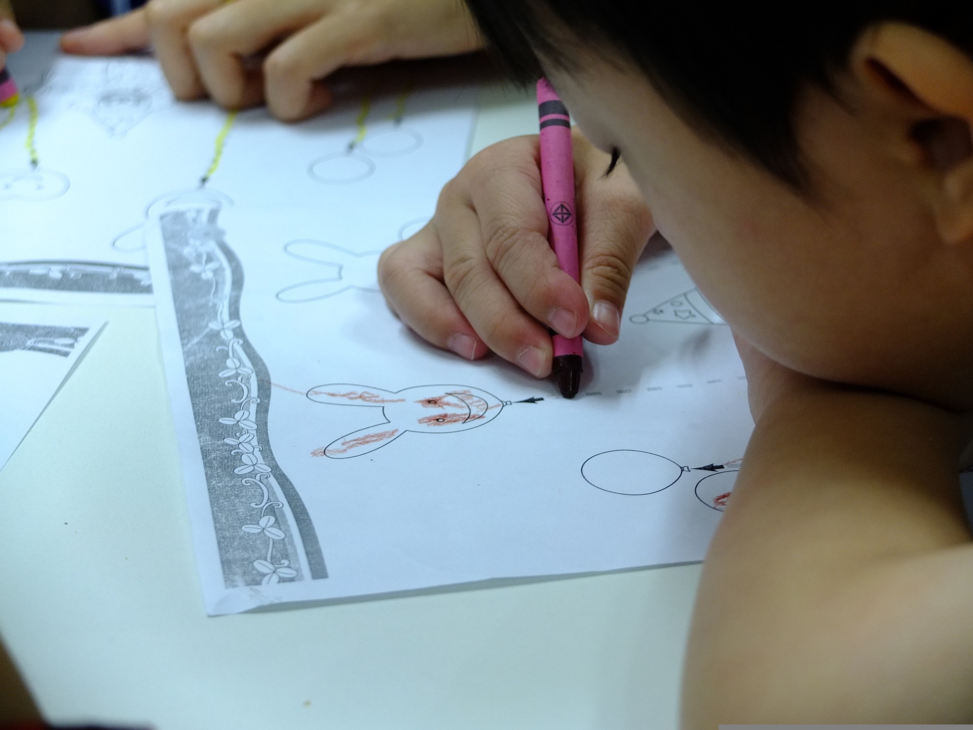 Child concentrating on a drawing activity.