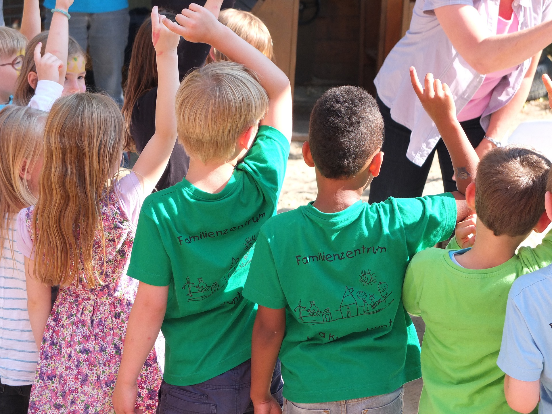 Children putting their hands up to speak.