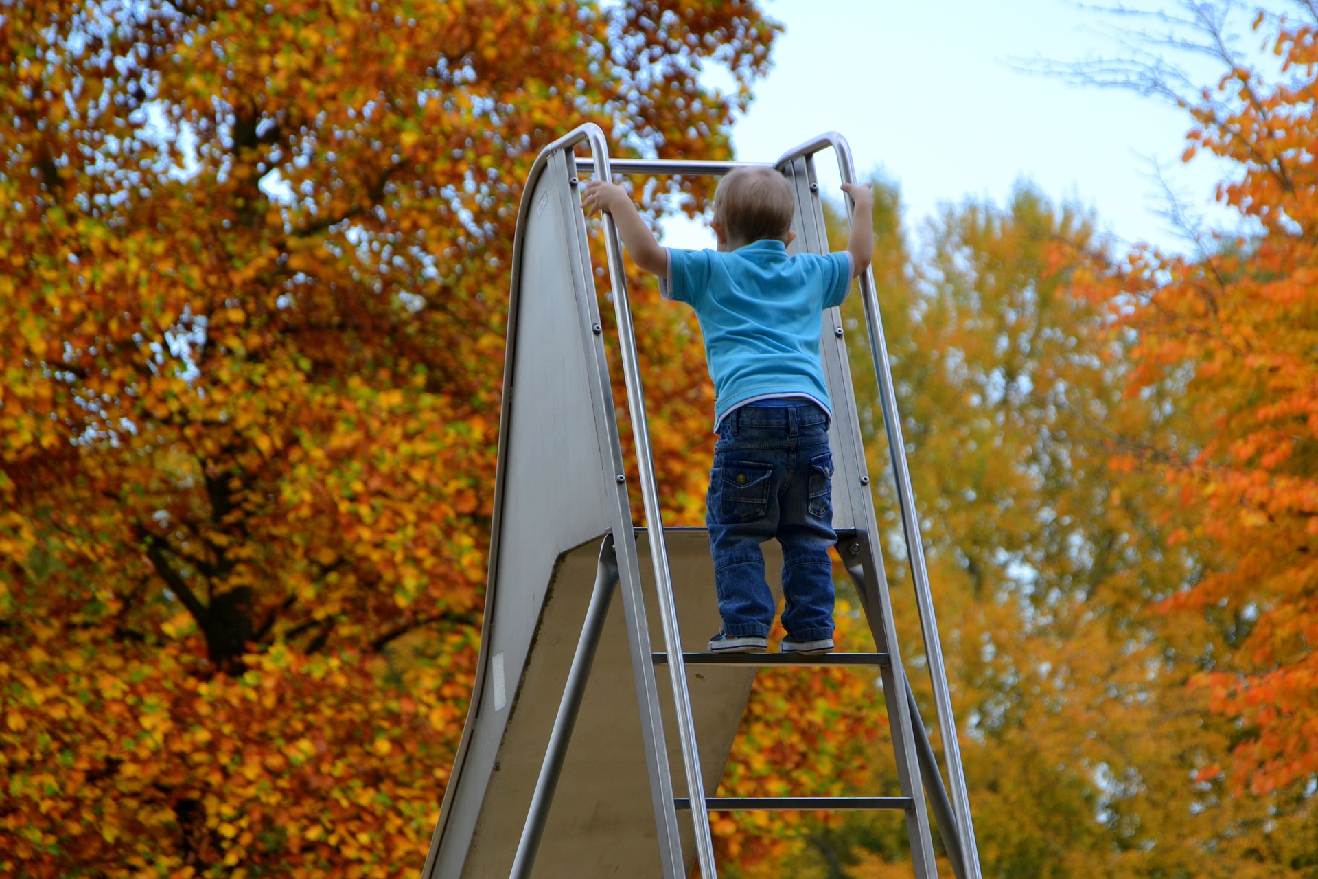 Child at the top of a tall slide